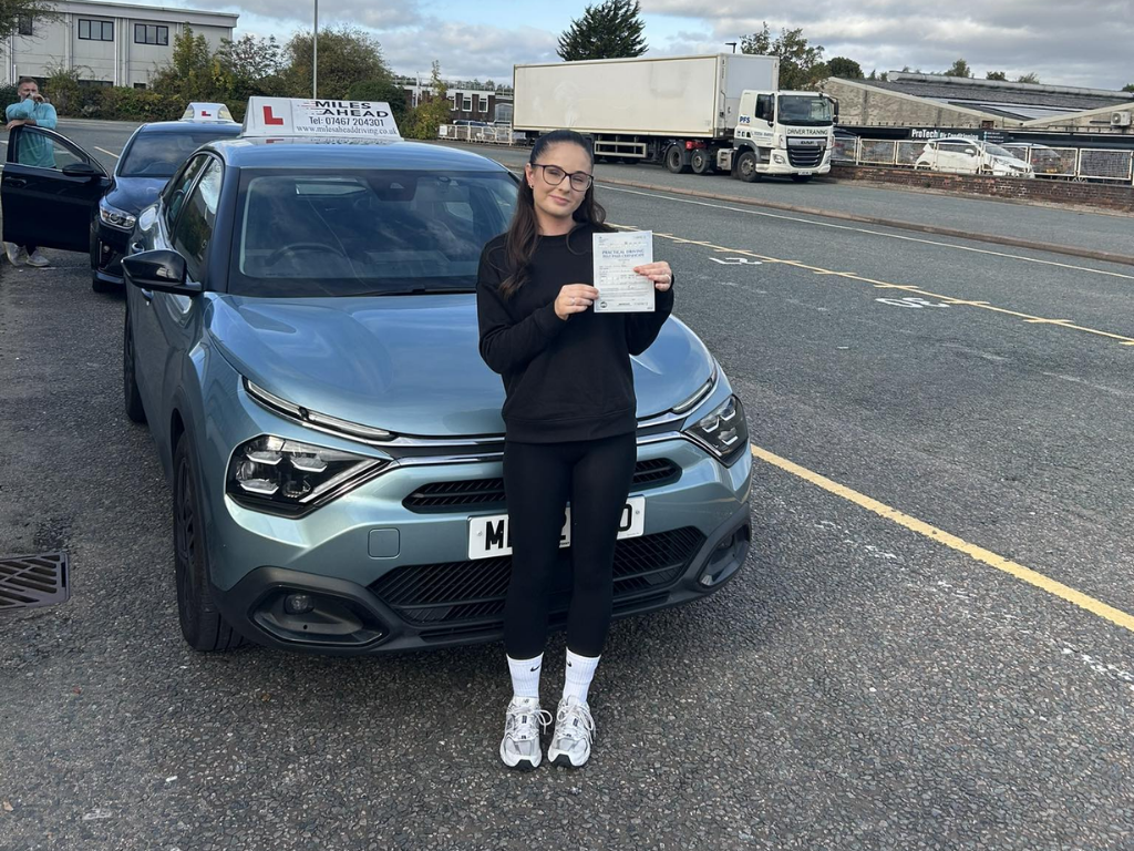miles ahead driving school student holding pass certificate
