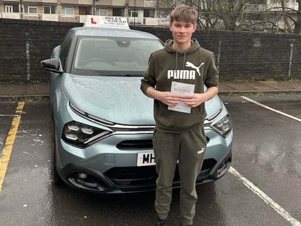 miles ahead driving school student rhys holding test pass certificate