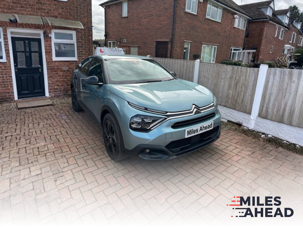 miles ahead driving school learner vehicle parked on driveway