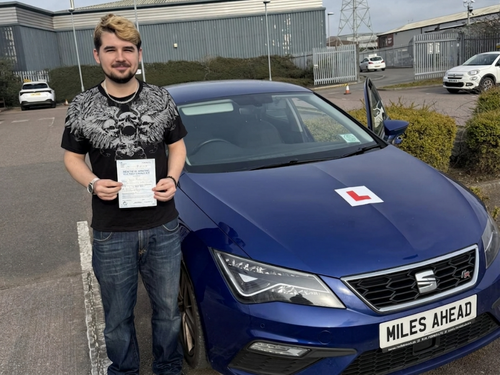 miles ahead driving school student dylan holding test pass certificate