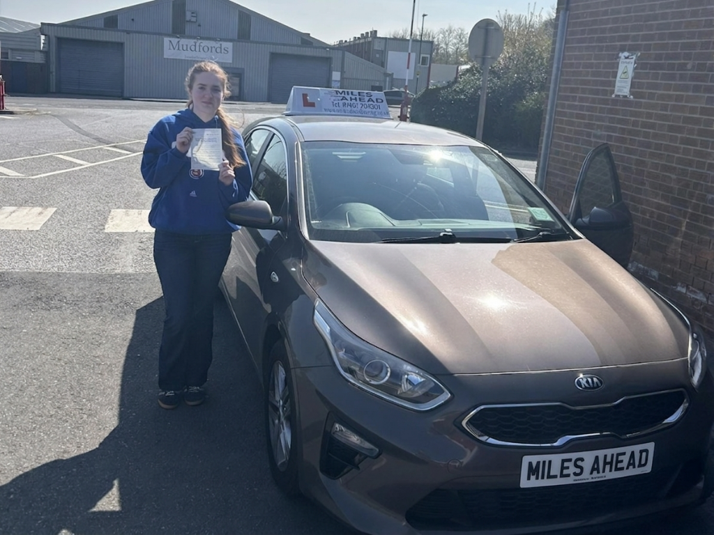 miles ahead driving school student beth holding test pass certificate